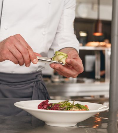 Chef preparing salad in the modern kitchen of restaurant. Tasty and healthy food. High quality photo