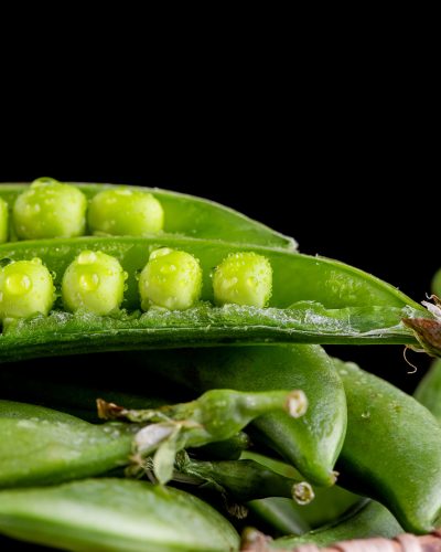 Sugar snap peas with mint on a rustic wood background