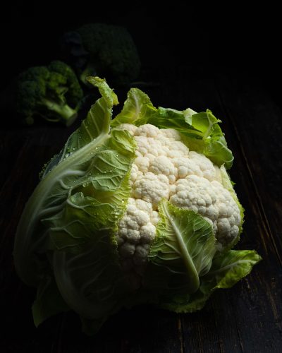 A vertical shot of a coleslaw isolated on a black background